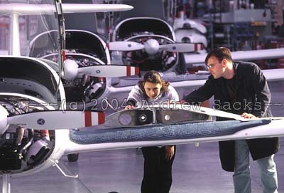 Instructor explains airplane mechanics to girl