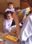 Pre-school teacher reads to class (Spain)