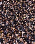 Crowd of graduates at college commencement 